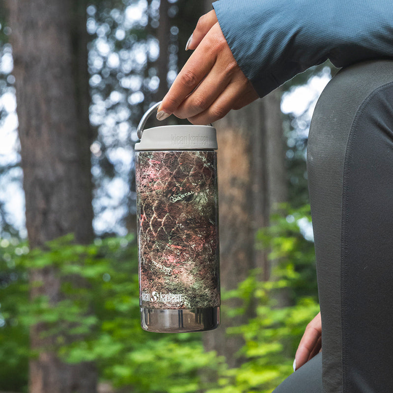 12oz-tkwide-with-twist-cap-mossy-oak-g7 12oz_tumbler_mossyoak_rainbowtrout_hand_closeup_square.jpg